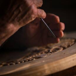 a person cutting a piece of wood